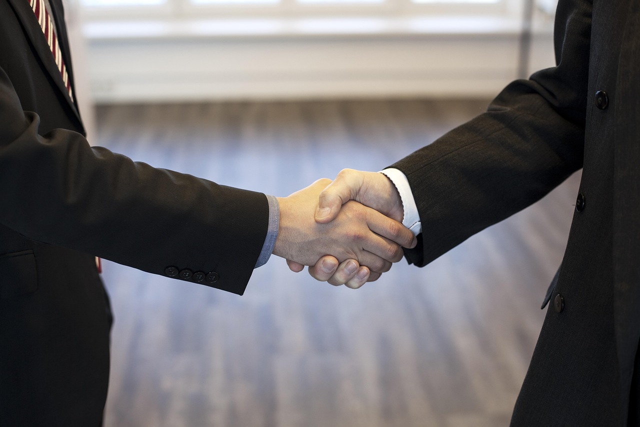 executive interim and leader shaking hands