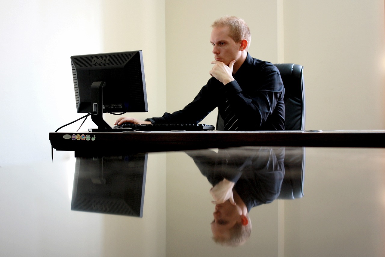 executive working on computer to hire an interim ceo